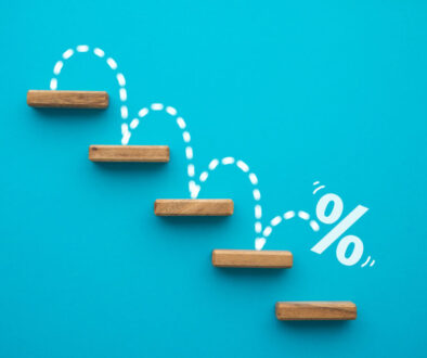 Percent sign moving down from top stair on blue background.